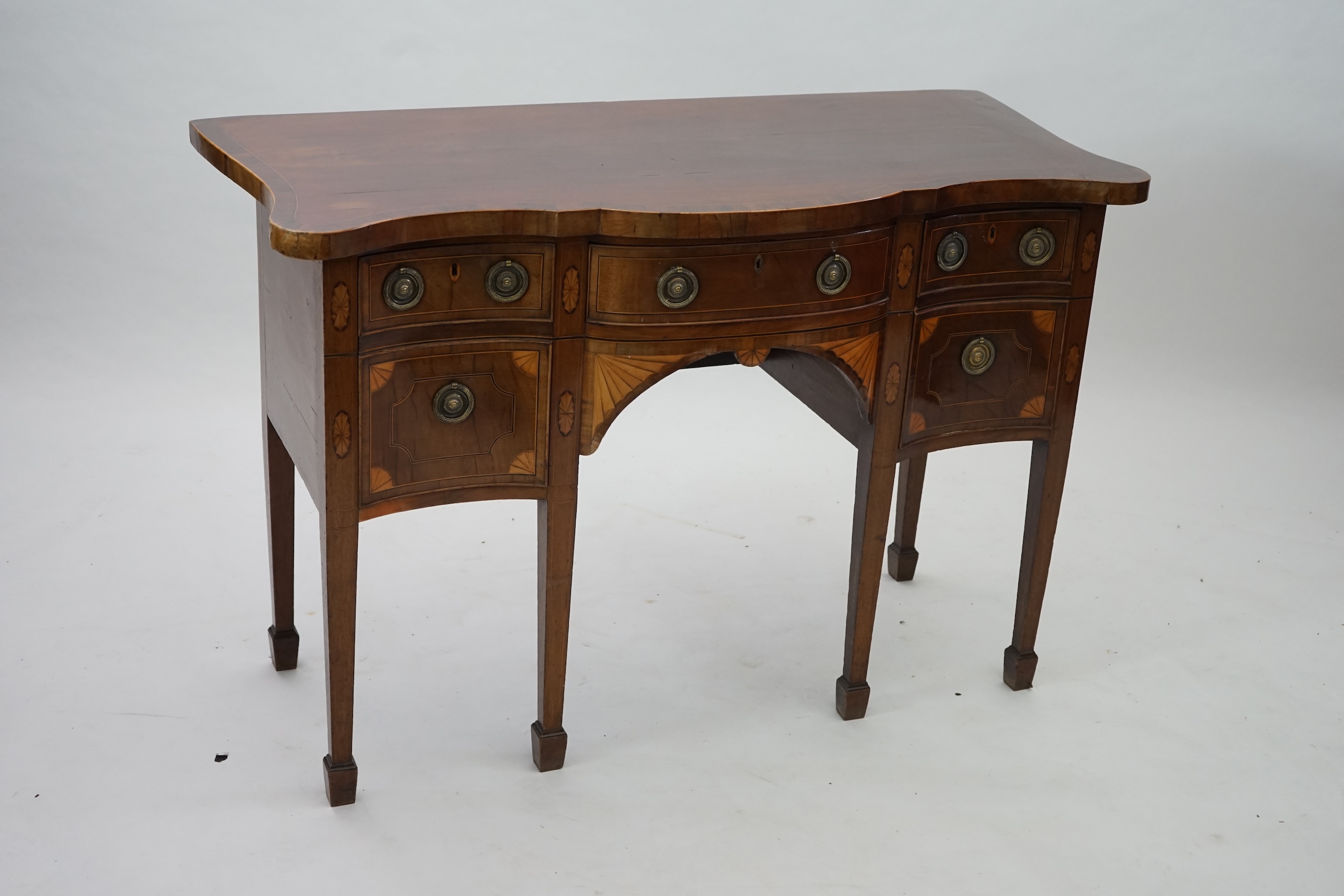 A George III inlaid mahogany serpentine sideboard